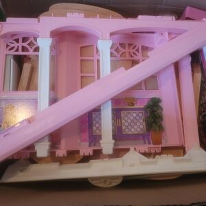 Pink and White Barbie dollhouse with working elevator and original furniture.